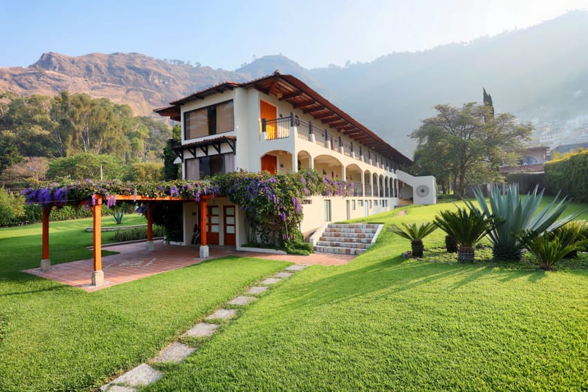 Edificio principal de Villa Santa Catarina con jardines y montañas